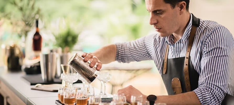 A bartender making cocktails.